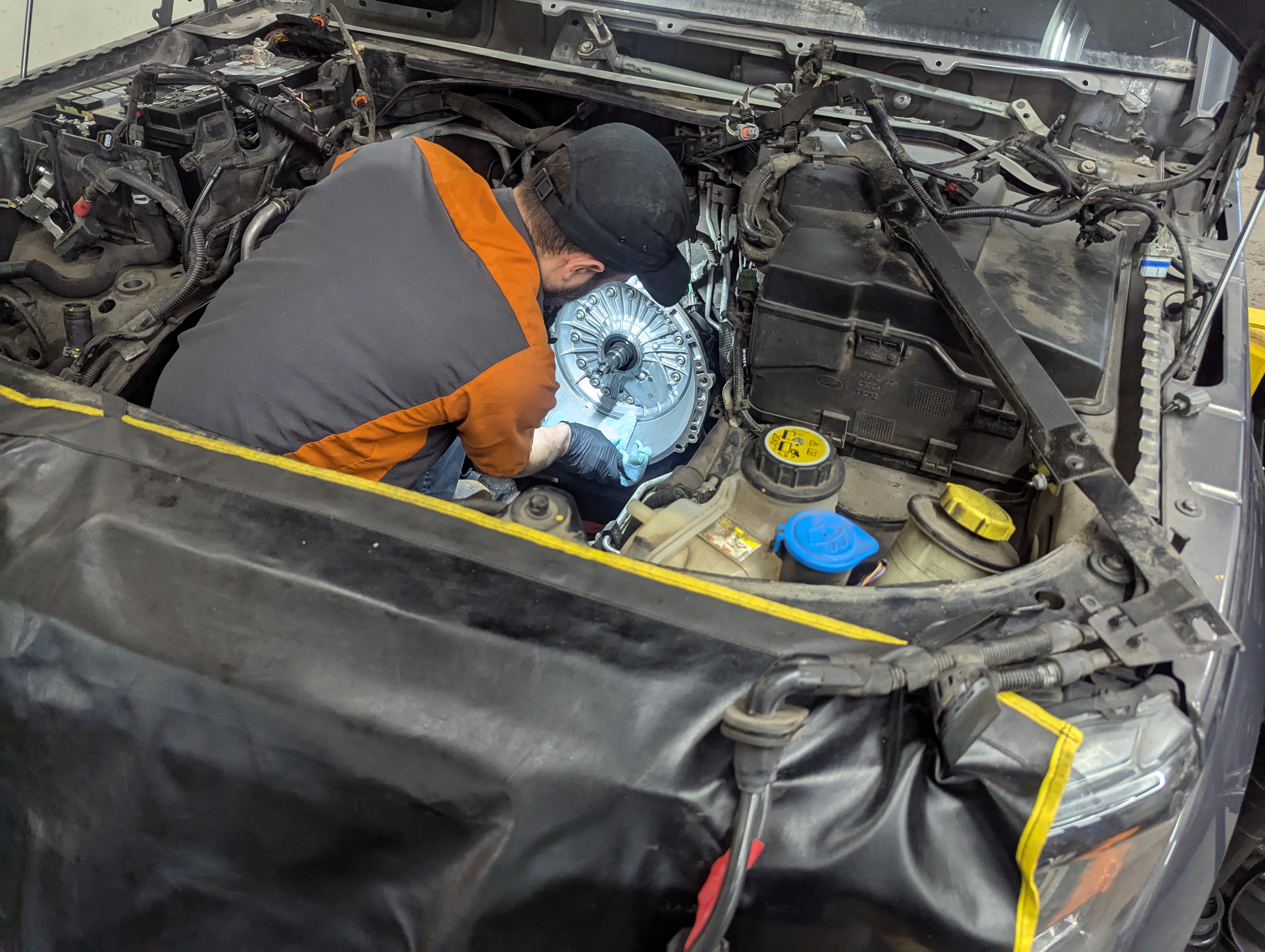 Technician installing clutch assembly on Land Rover LR4 at Lux AutoHause